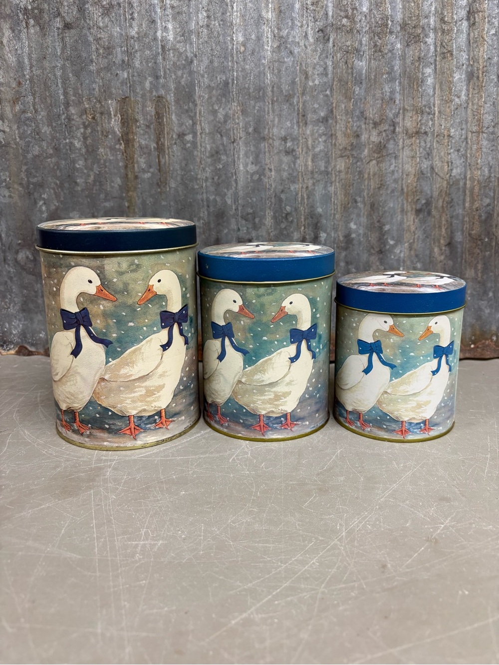 Set of three vintage 1980s nesting tin canisters
